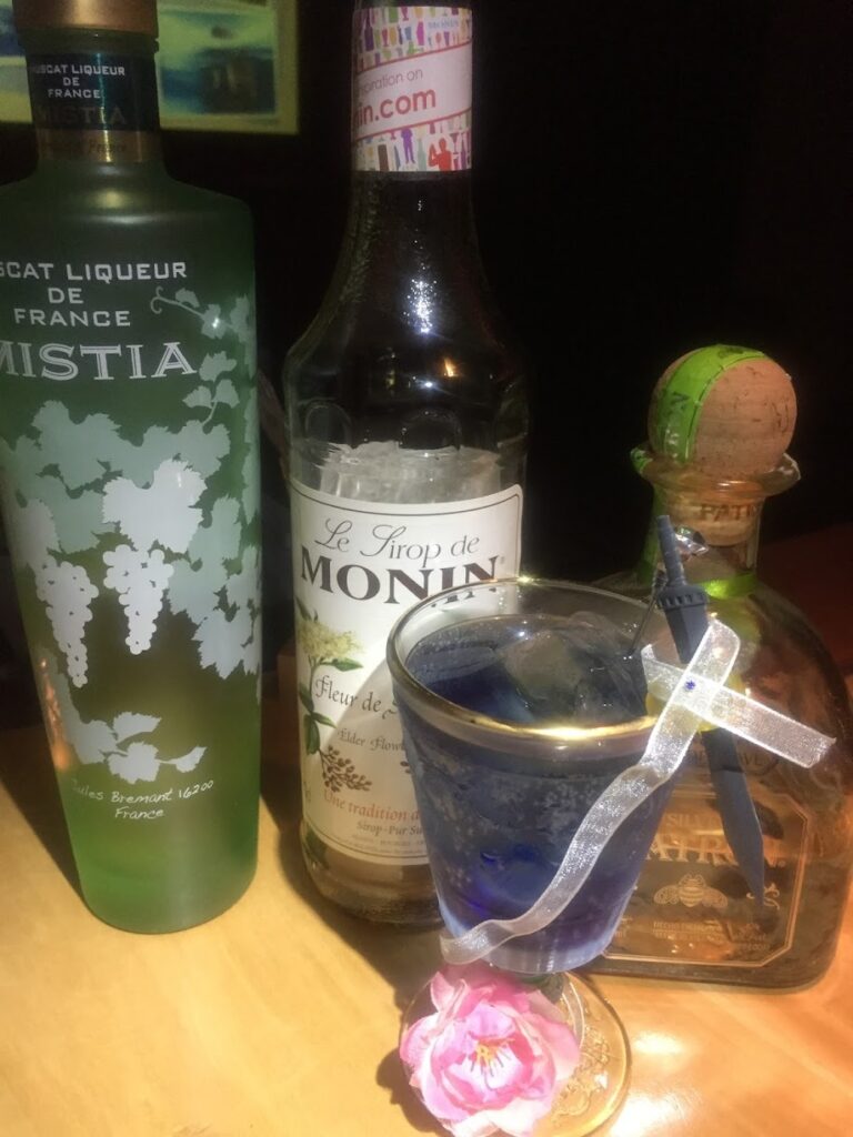 A photograph of a cocktail and its ingredients