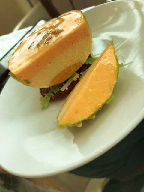 a mousse cake made to look like half of a melon